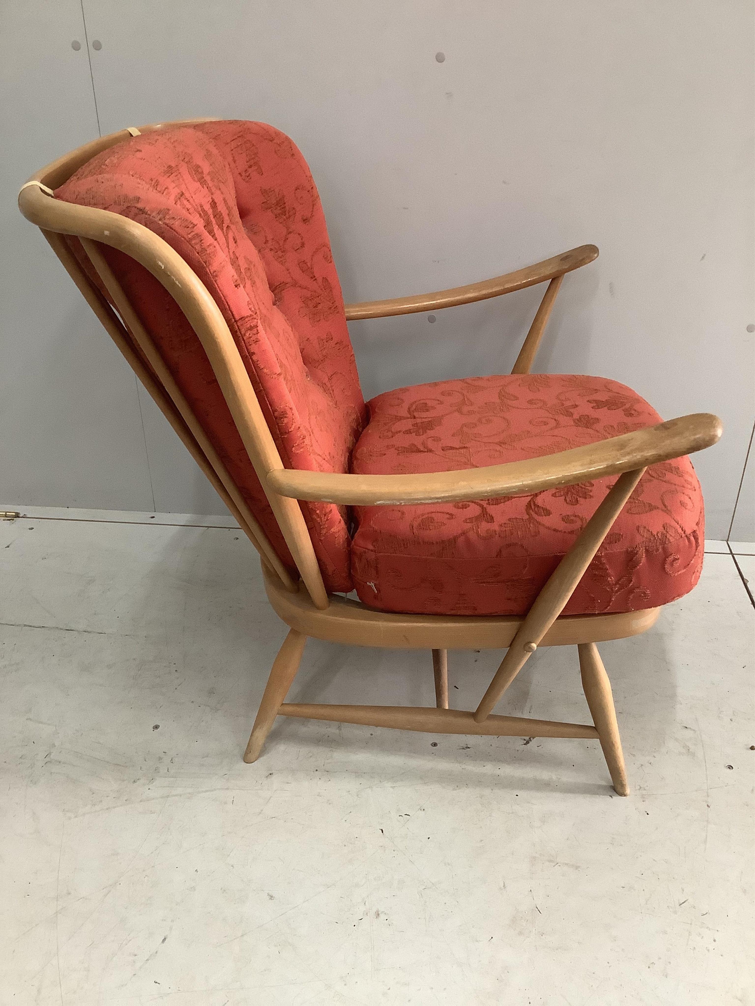 An Ercol golden beech armchair, width 73cm, height 82cm. Condition - rubbing to the tips of the arms, otherwise fair